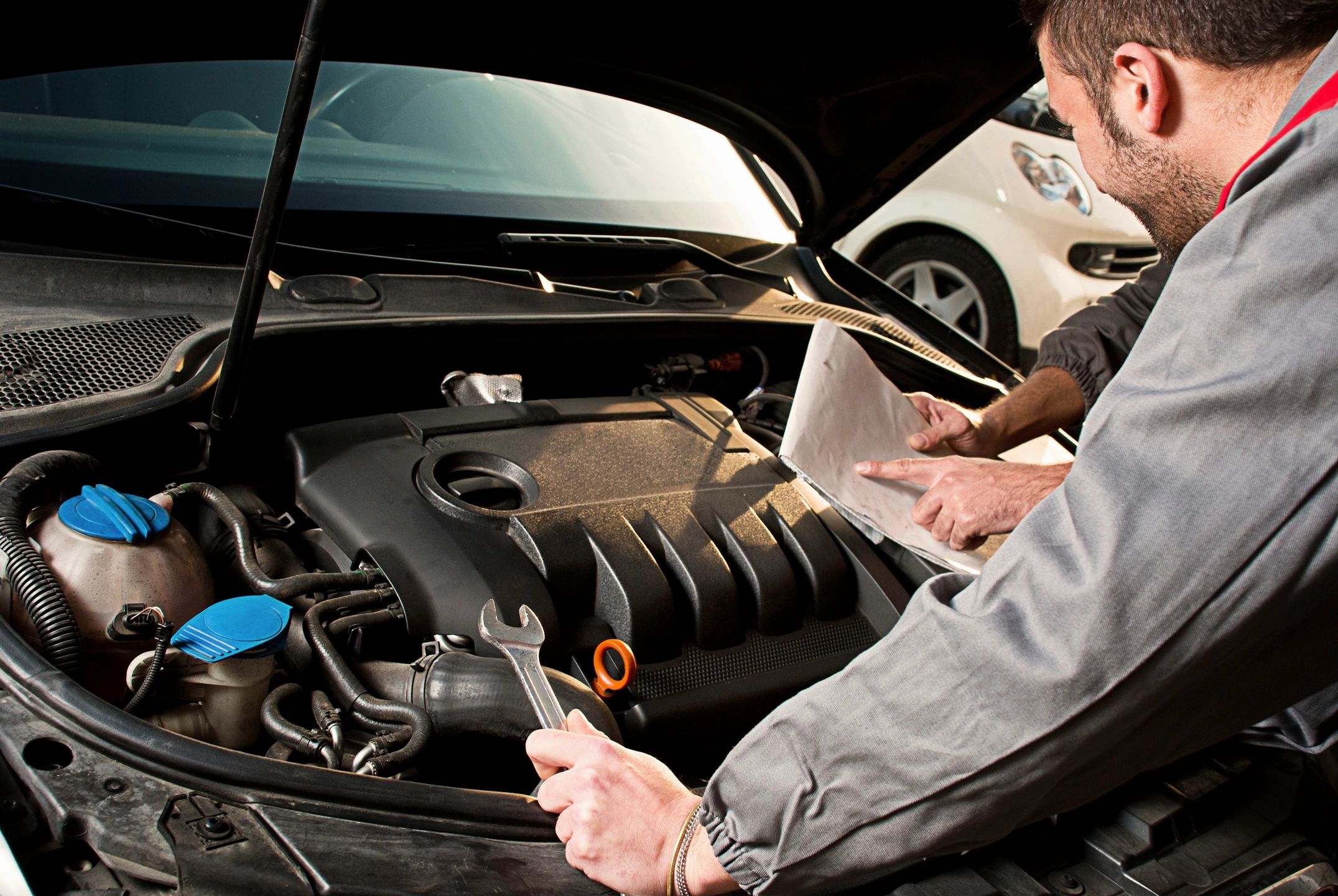 Mechanic inspecting a vehicle engine